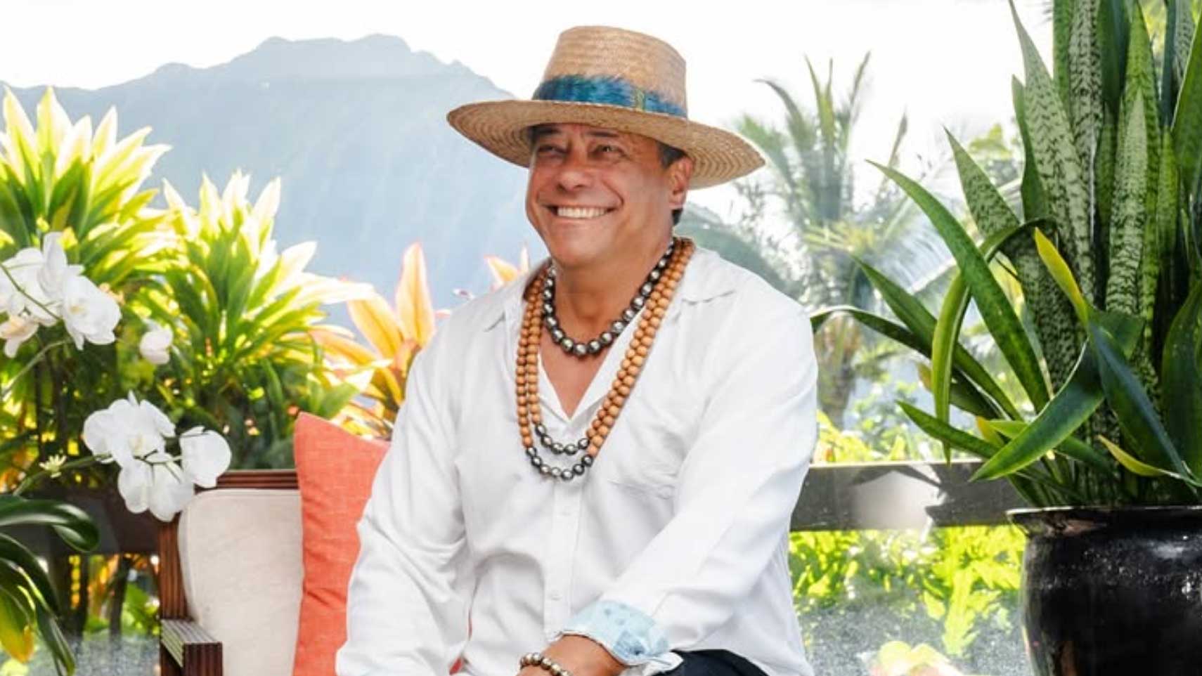 Mana Gunderson wearing pearl necklaces in a tropical garden